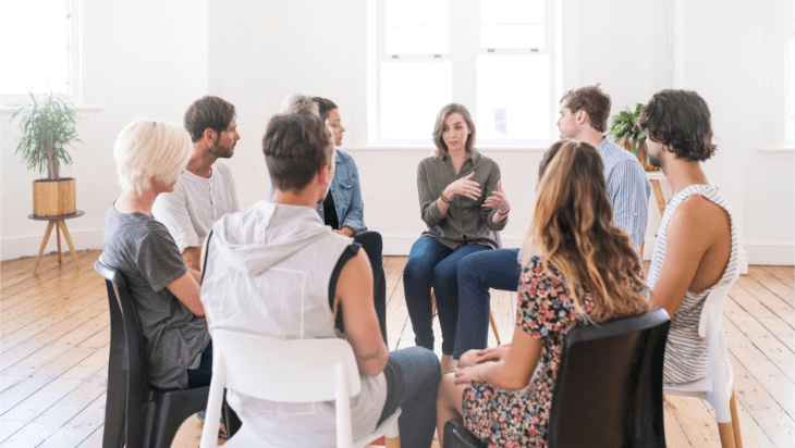 A woman talking to a support group
