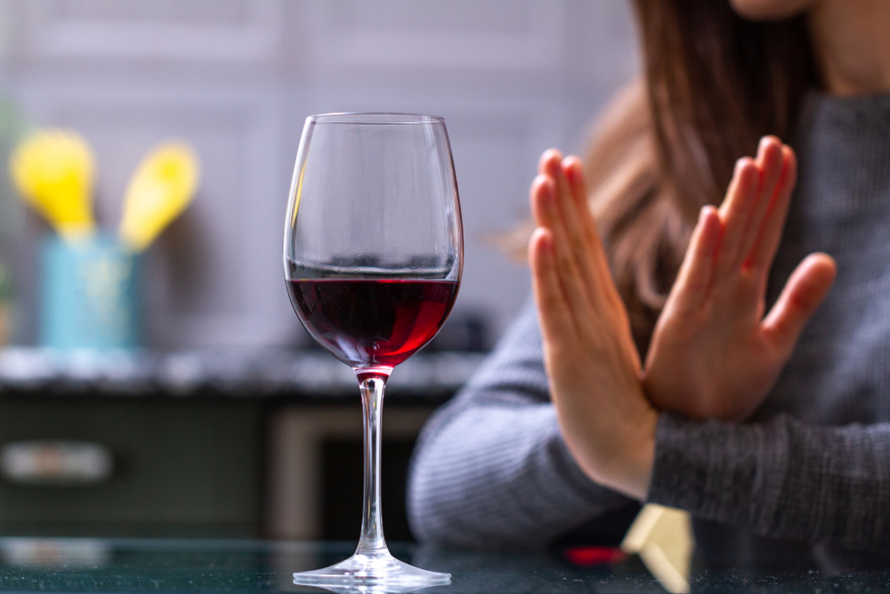 Woman saying no to alcohol after drug and alcohol addiction treatment