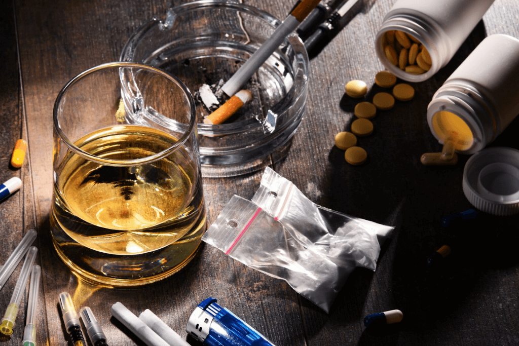 Drugs and alcohol spread across a table