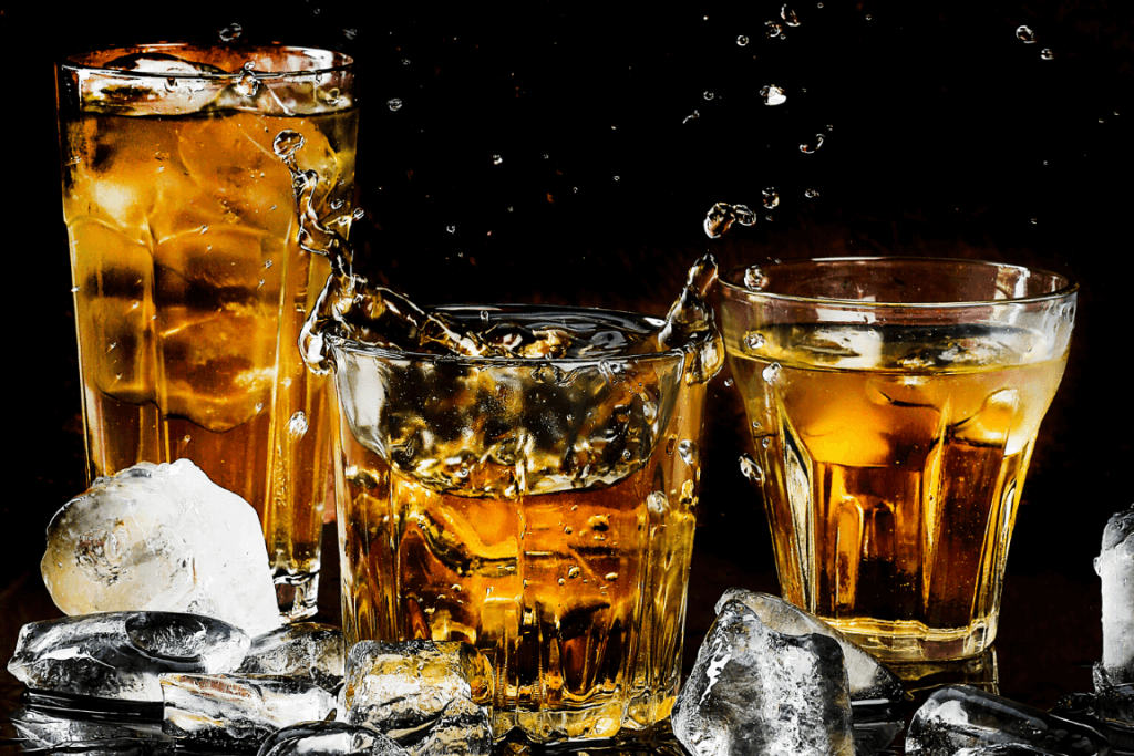 Close up of three glasses filled with alcohol