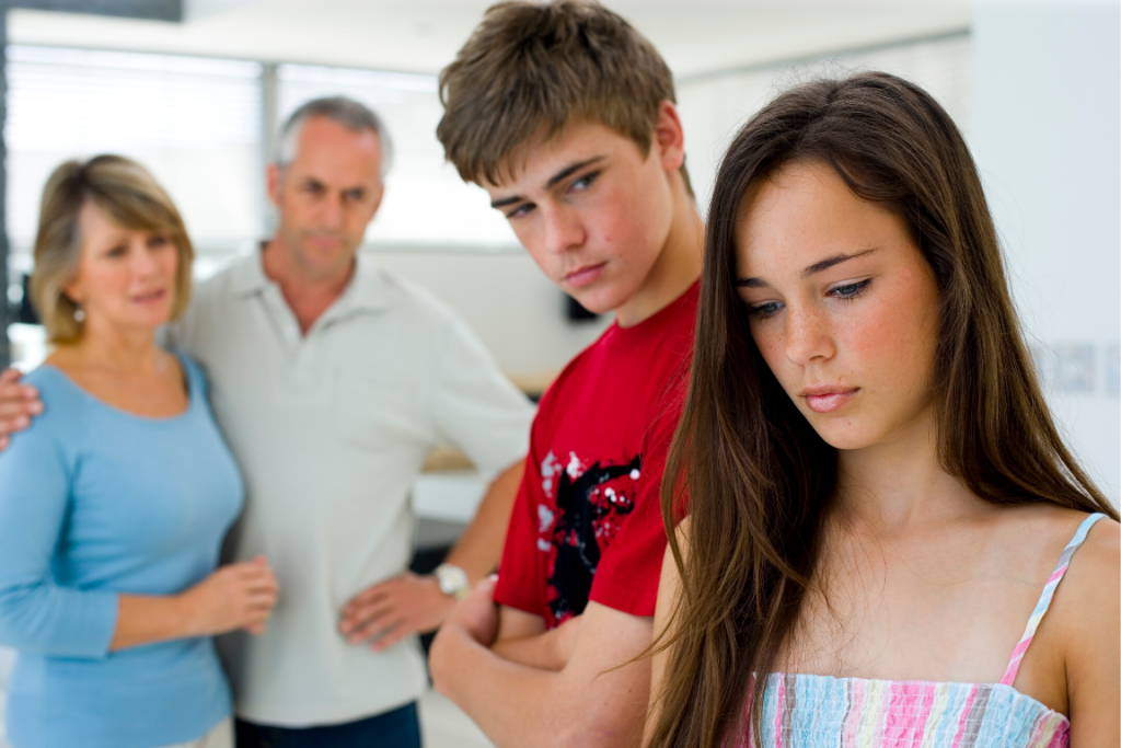 A family gathered, looking concerned for their daughter.