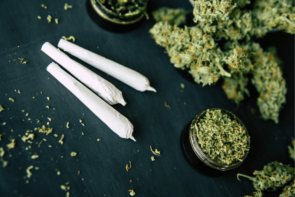 Close up of joints and loose marijuana on a table