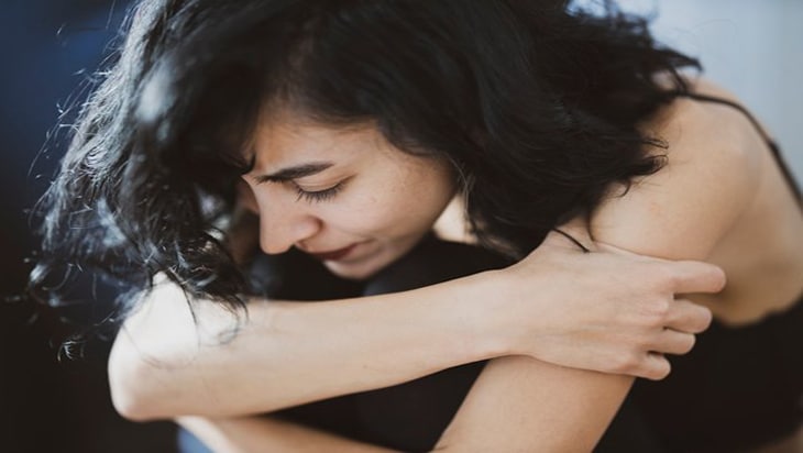 Woman hugging herself