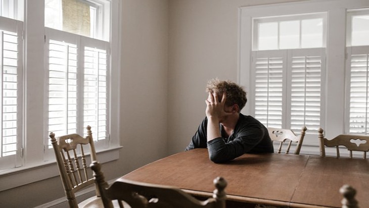 A depressed man in the dining area