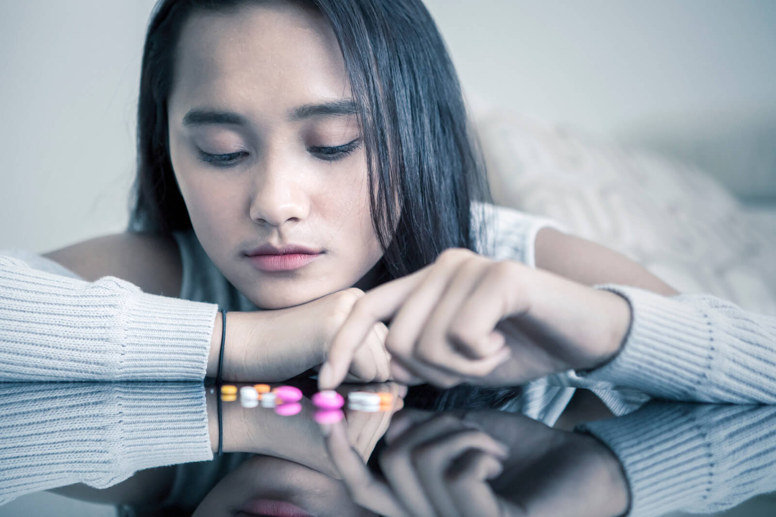 Woman thinking about taking pills