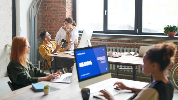 People in an office working in front of the computer