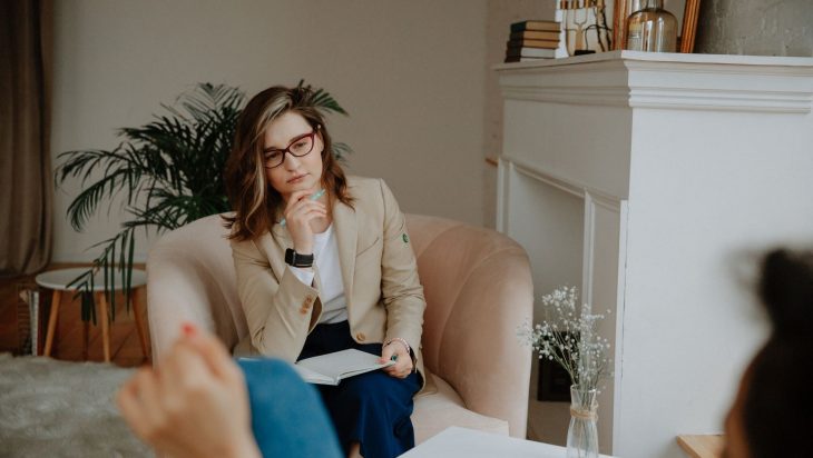 A psychotherapist listening to a client