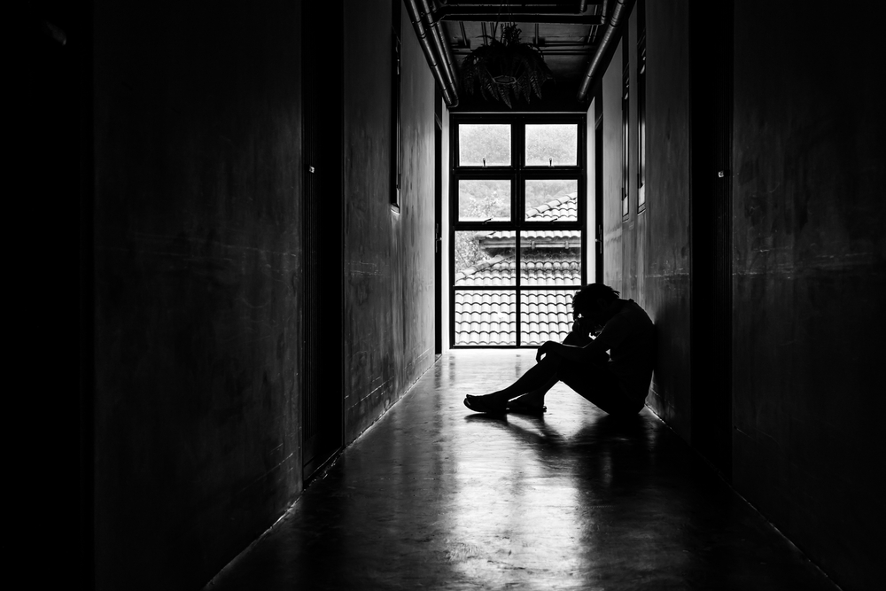 Lonely man in a dark corridor