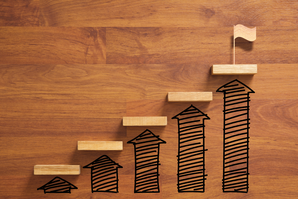 Pieces of wood with upward arrows symbolizing progress