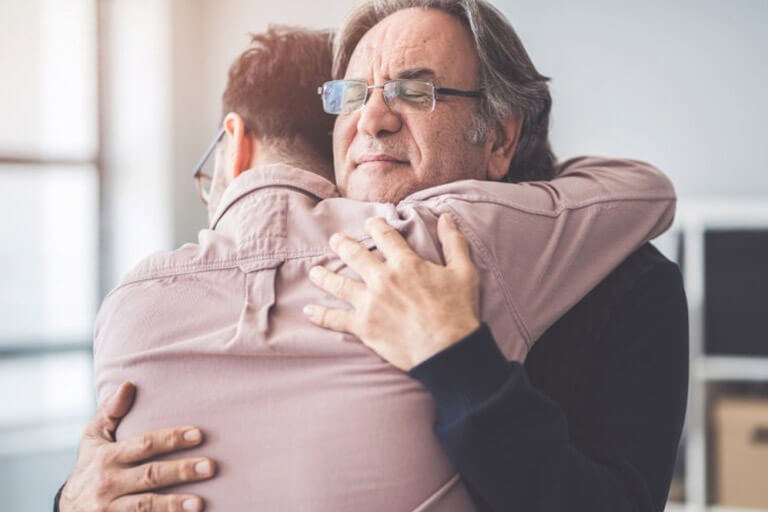  A recovered patient hugs his therapist in gratitude
