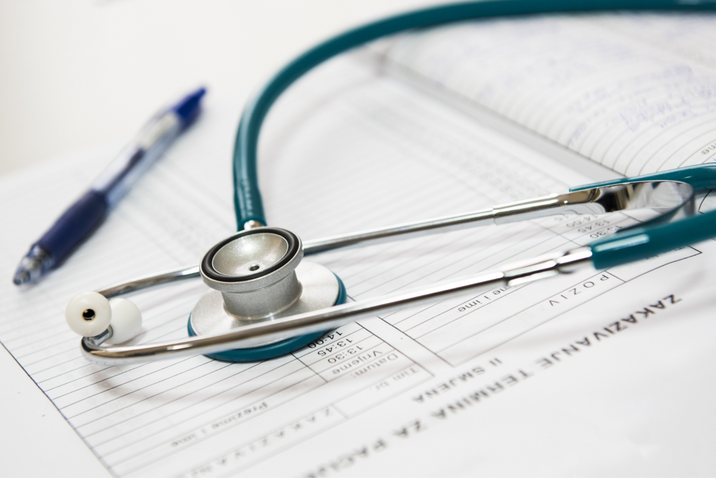 CLose up of a stethoscope and prescription pad
