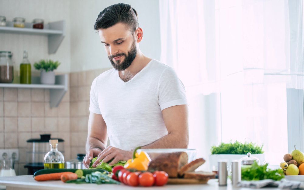 Man preparing a healthy meal in the kitchen.