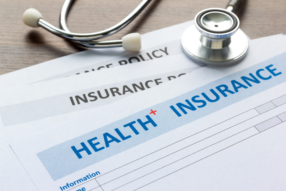 Health insurance documents with a stethoscope.