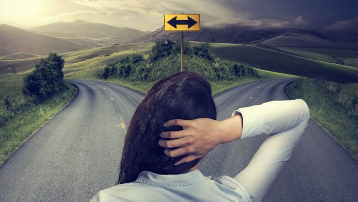 A woman facing a fork in the road