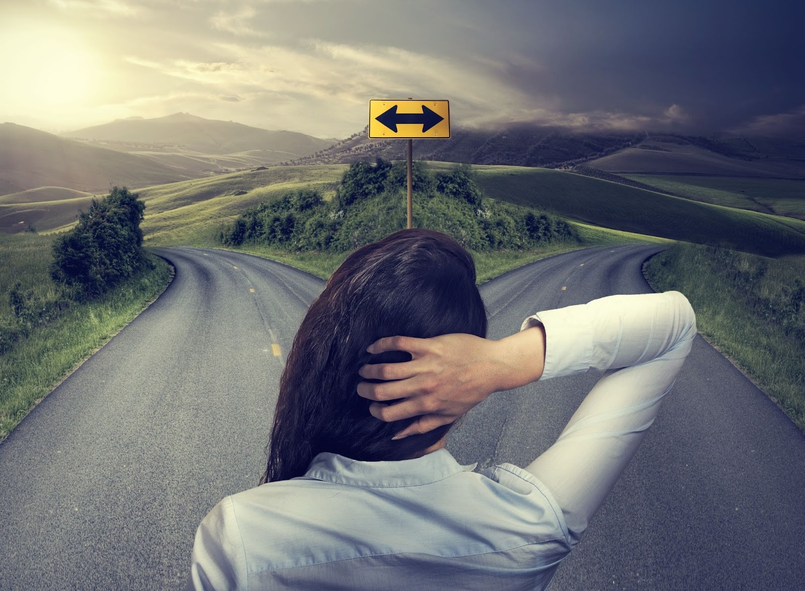 A woman facing a fork in the road
