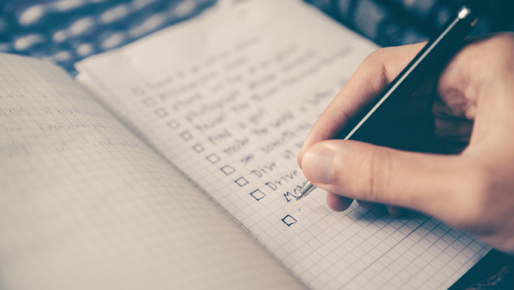 A person writing their goals down in a notebook