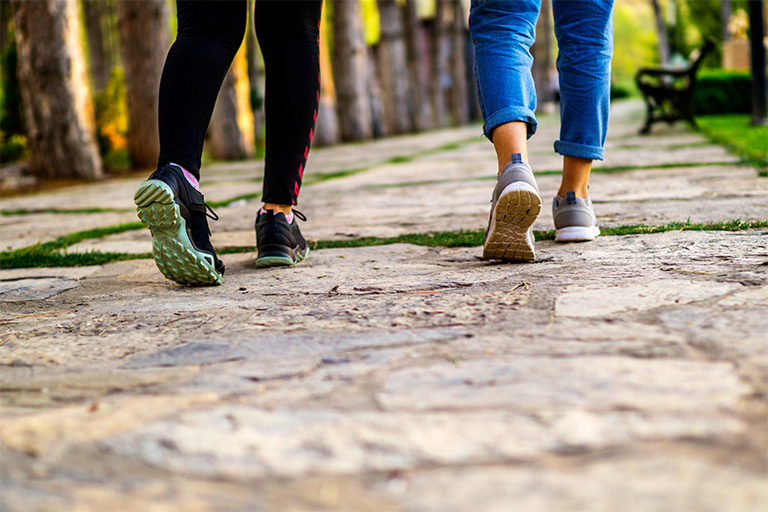 Two people going for a walk in a park