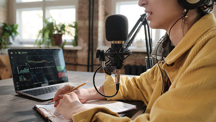 a woman recording a podcast about mental health