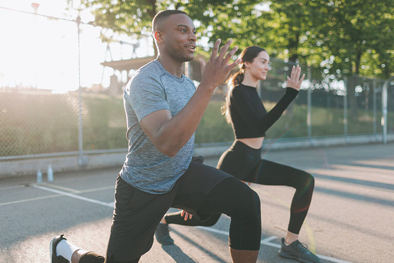 Two people working out as a distraction from drinking
