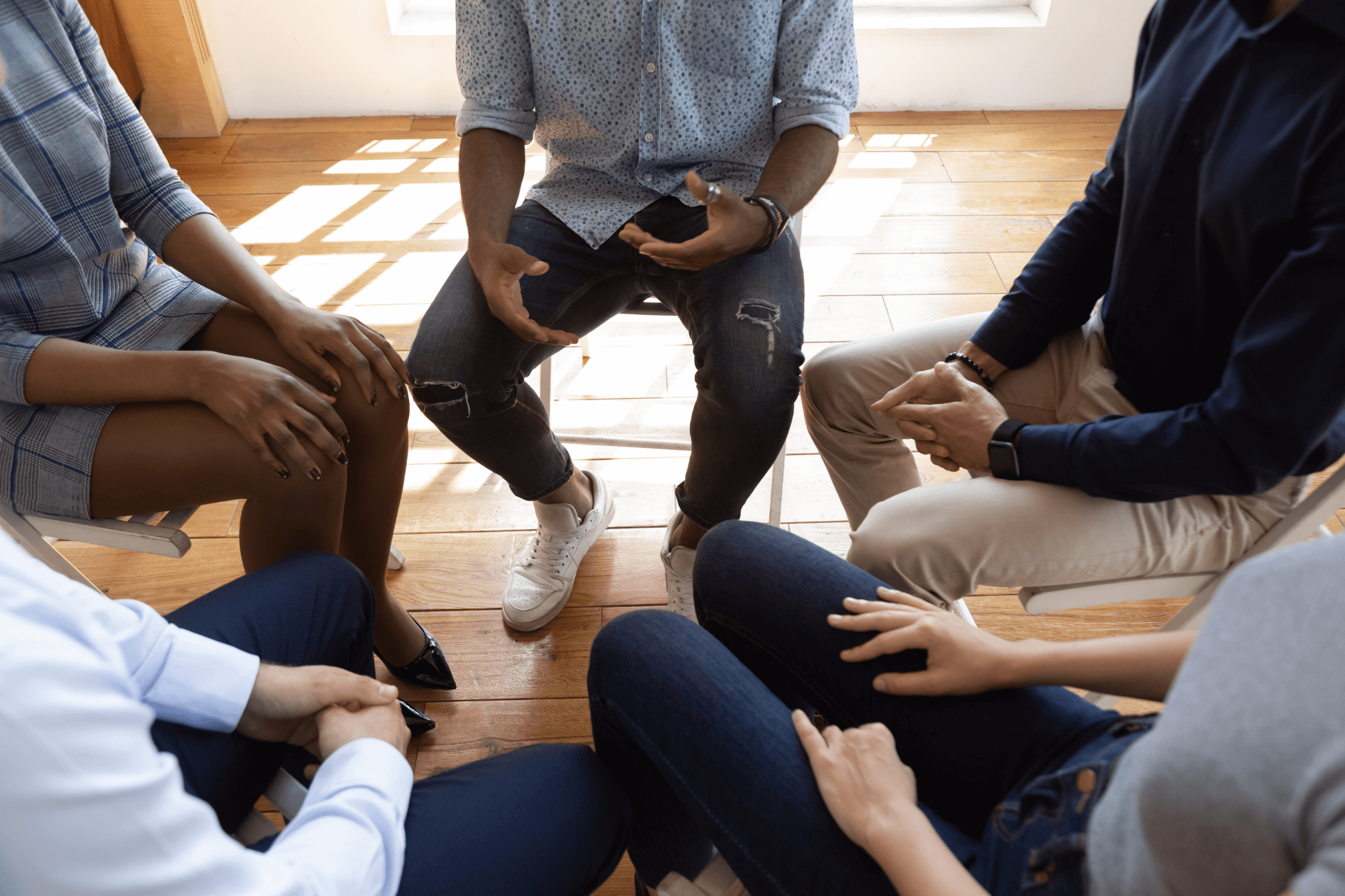 A group of people participating in therapy while in addiction recovery