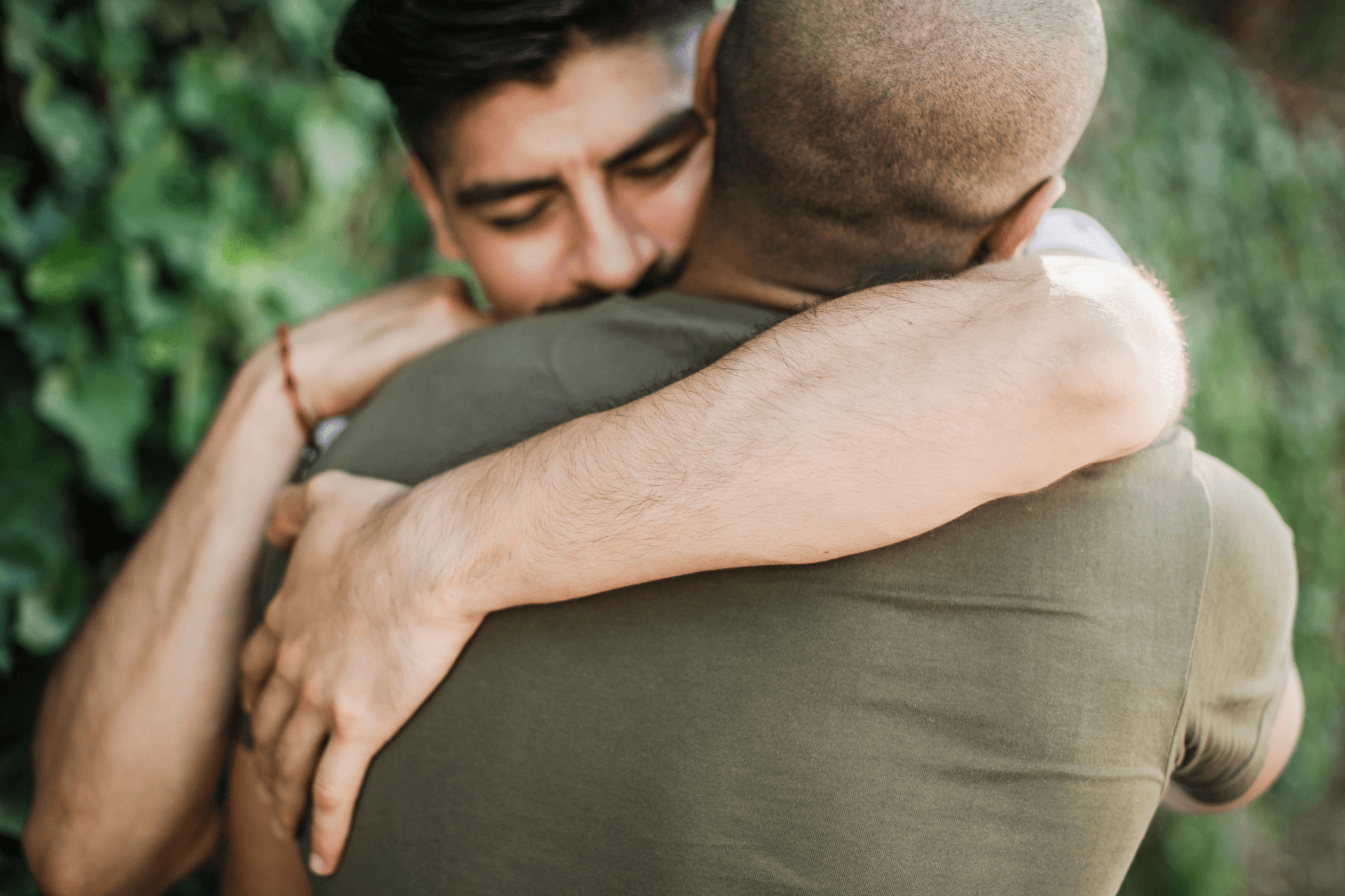Two men hugging after an apology