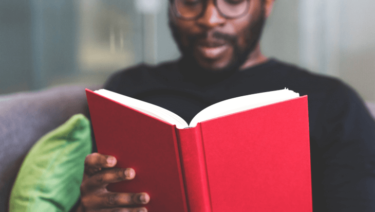 A man reading a book about mental health