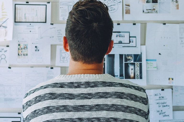  A person looking at a board full of tasks.