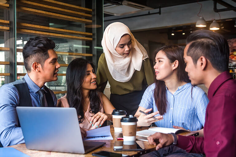 a group of employees support one another at work