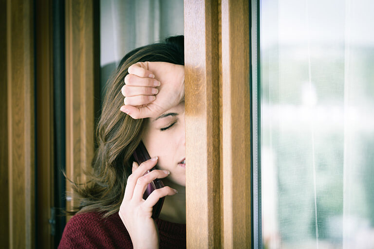 a woman on the phone with her AA sponsor