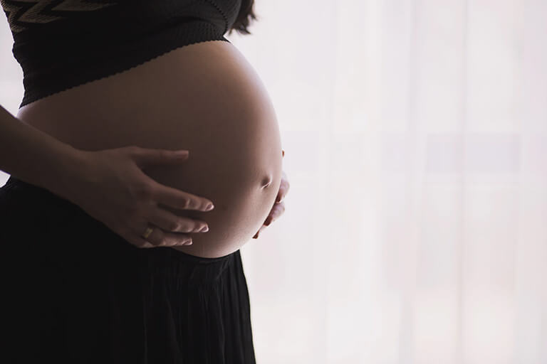 A pregnant woman showing her belly