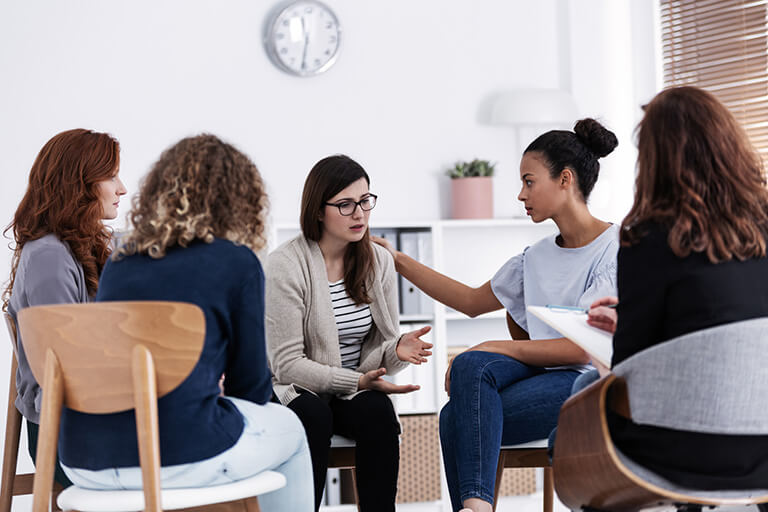 women in a group therapy setting