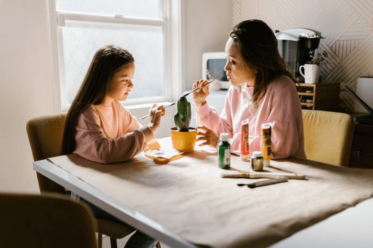 a mother and daughter talk over art therapy