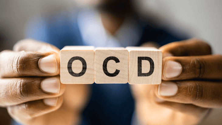 The letters “OCD” written on blocks of wood