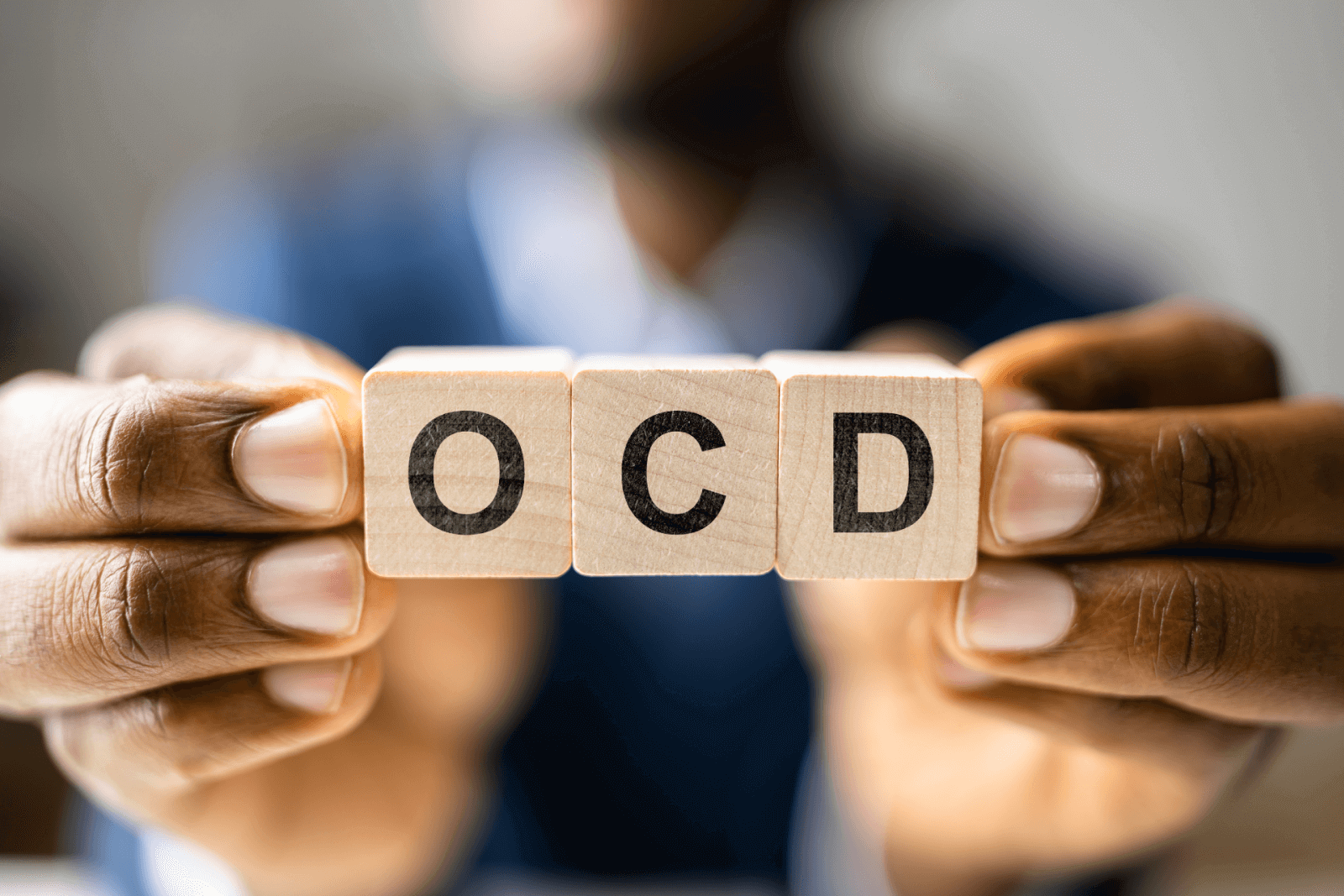 The letters “OCD” written on blocks of wood