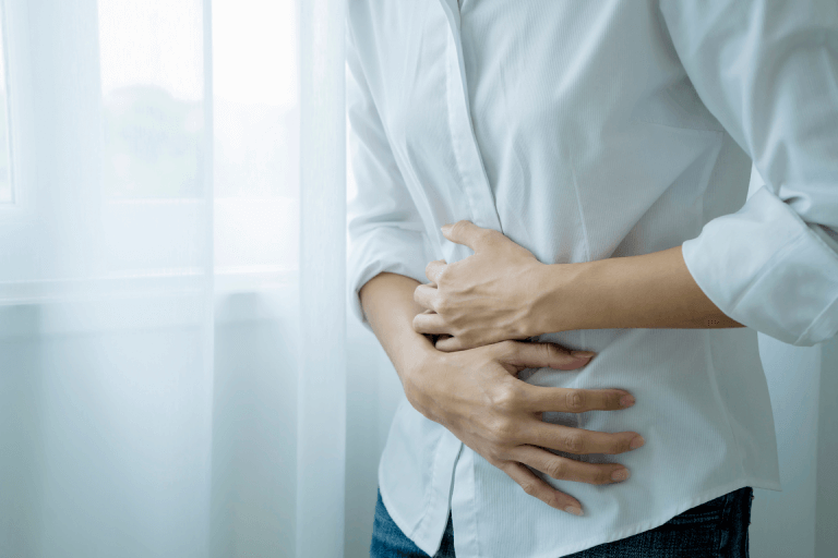 Someone clutching their upset stomach.