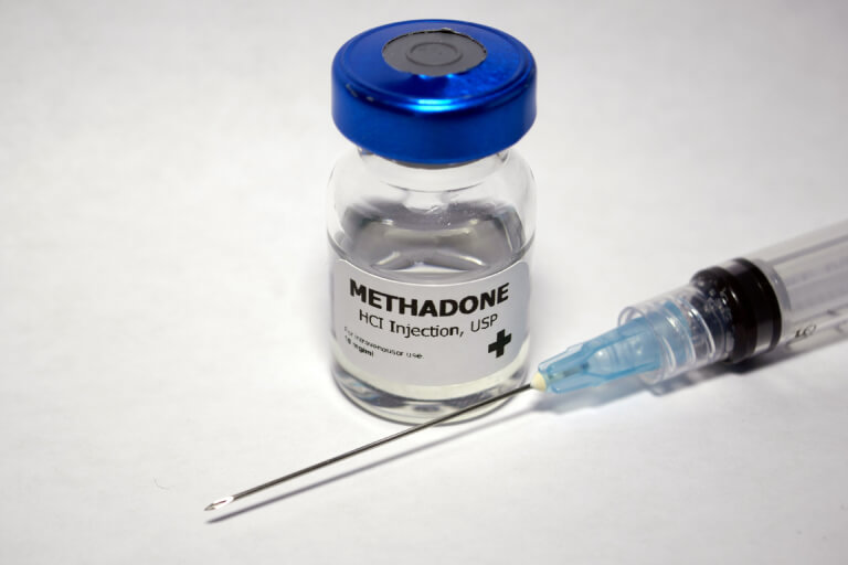 A methadone syringe and prescription bottle