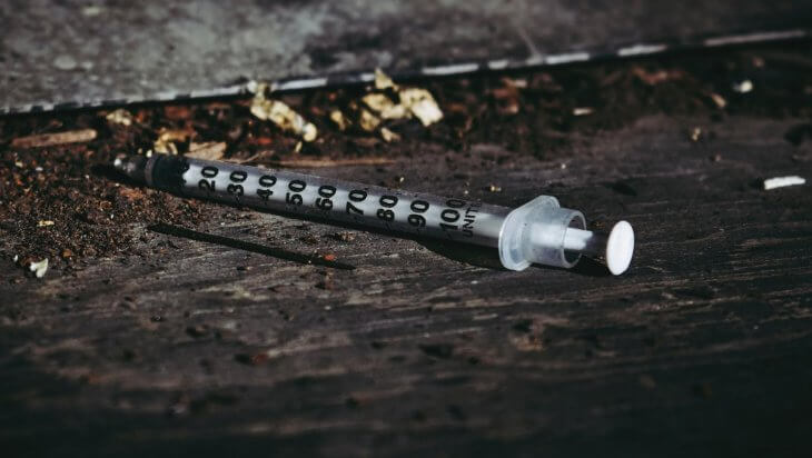 A disposed syringe on the ground