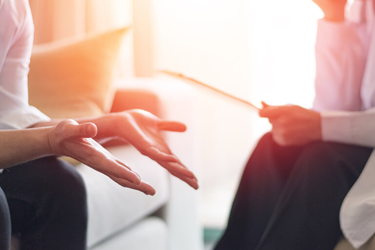 A patient speaking with an addiction specialist
