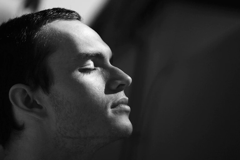 A man with closed eyes meditating