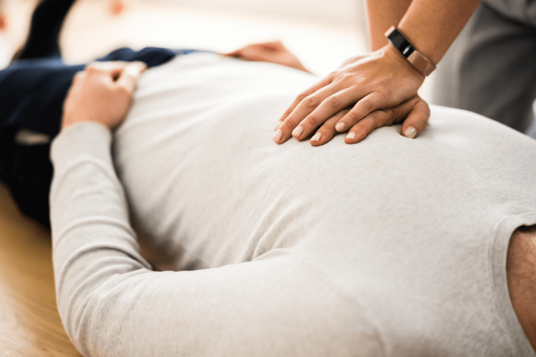 a person administering CPR on a patient