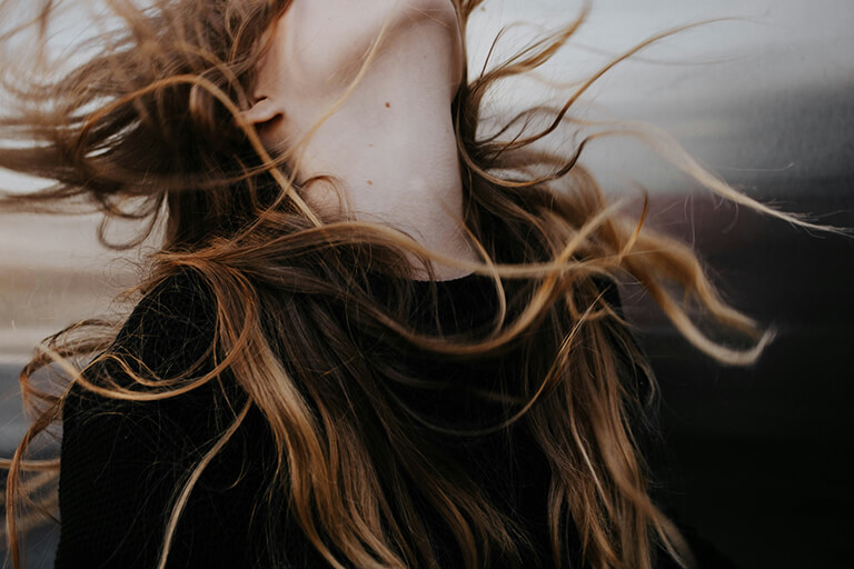 A woman letting her hair fly in the wind