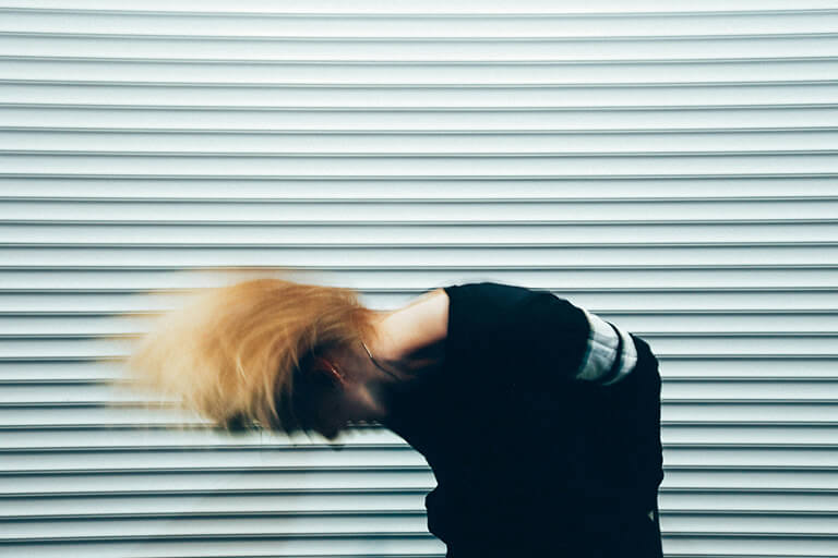 A person whipping their head side to side