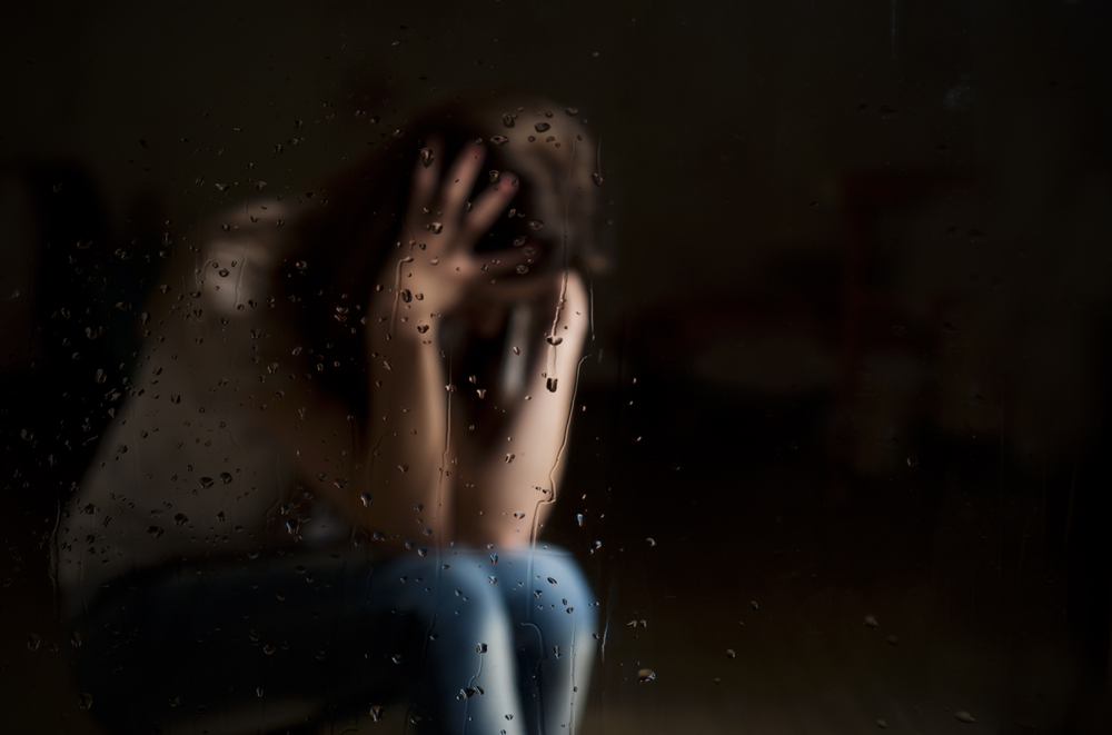 Image of a woman behind glass