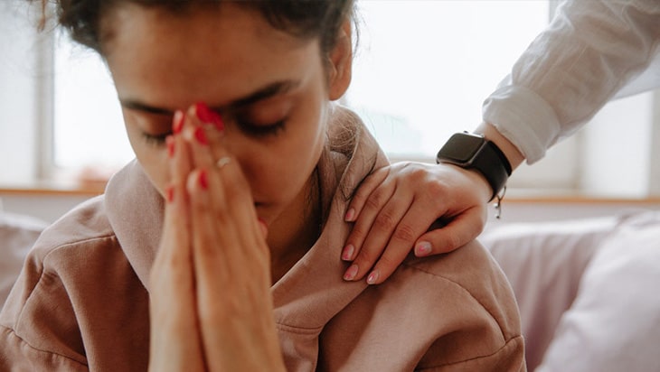 Woman being comforted by a friend