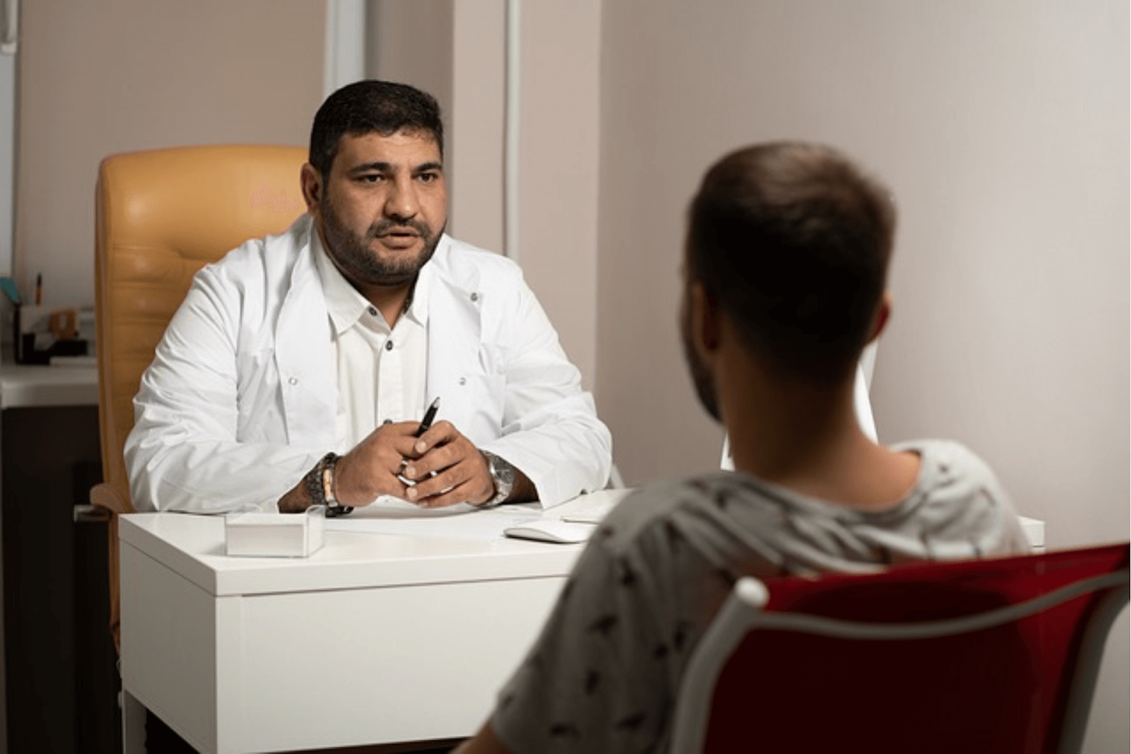 A doctor discussing types of alcoholism with a patient.